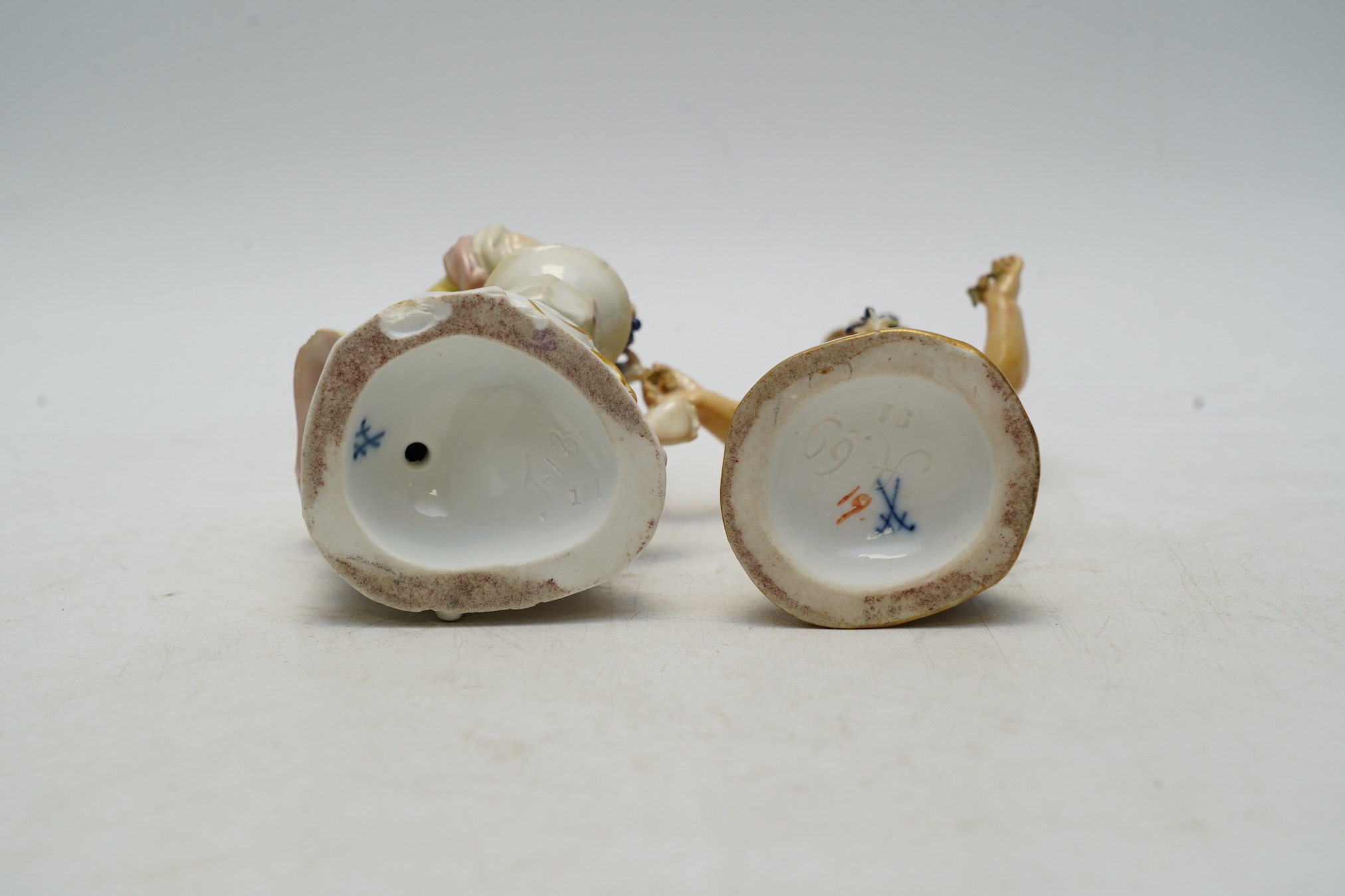 Two Meissen porcelain figures, boys with grapes, largest 13cm high. Condition - poor